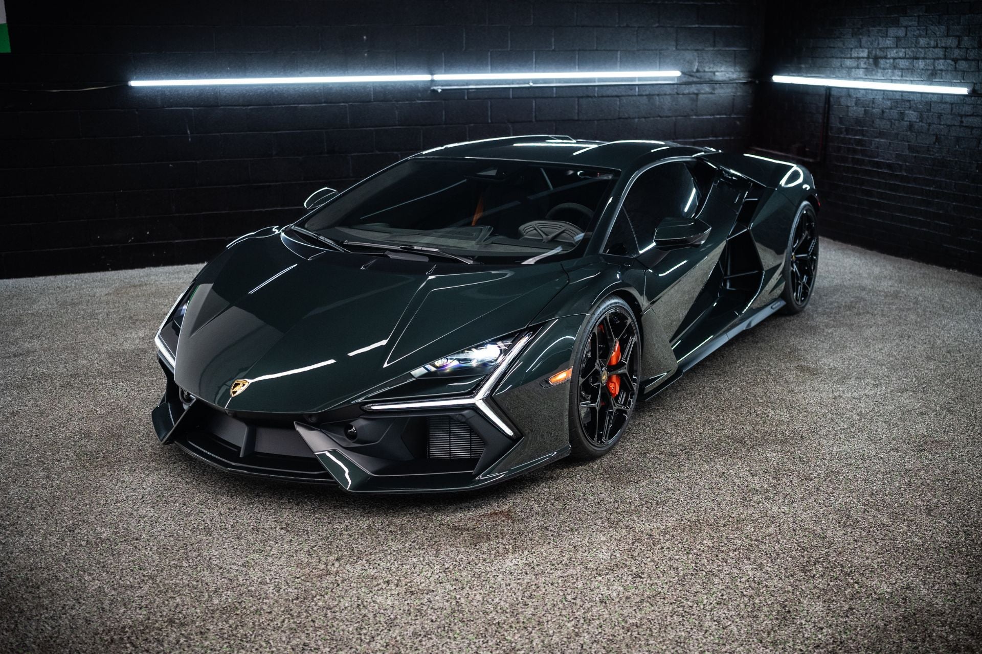 A Lamborgon parked in a dimly lit room, showcasing its sleek design and glossy finish.